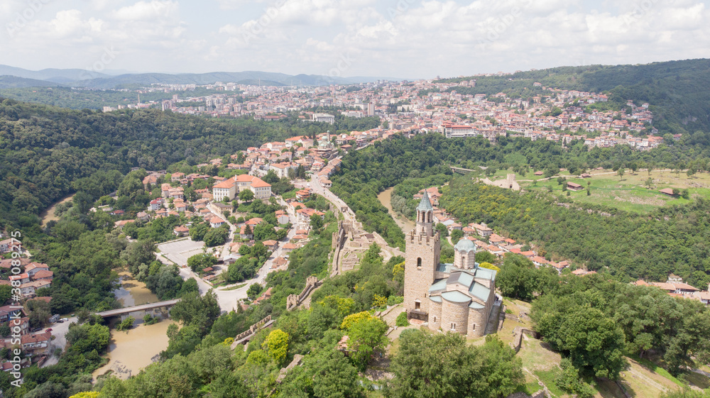 Old Balkan fortress on Bulgaria, world heritage in Veliko Tarnovo. Historical structure medieval castle on a hill. Drone aerial view of sightseeing monument landmark. Cultural Stronghold