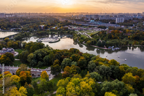 a panoramic view of the ancient palace and a large green park complex with a lake filmed from a drone