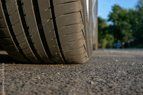 Car wheel on the asphalt, close-up. 