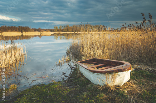 Fototapeta Naklejka Na Ścianę i Meble -  A small boat on the shore of a lake