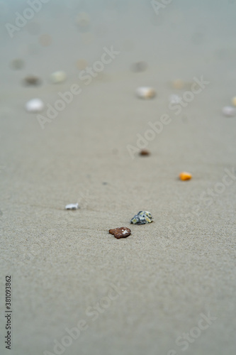 unique stones lie on a sandy background, selective focus with blur.
