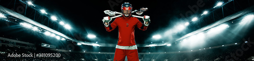 Lacrosse Player, athlete sportsman in red helmet on stadium background with lights. Sport and motivation wallpaper. Wide banner. photo