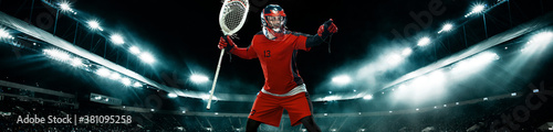 Lacrosse Player, athlete sportsman in red helmet on stadium background with lights. Sport and motivation wallpaper. Wide banner.