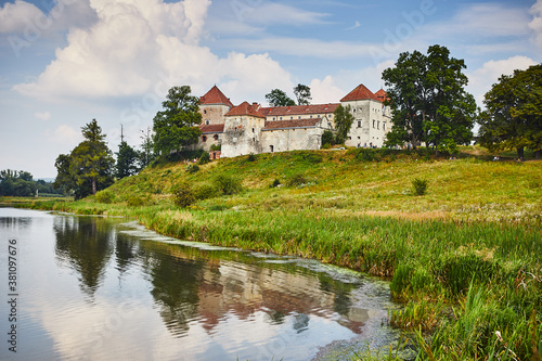 Ancient Svirzh castle with lake and trees in Lviv region