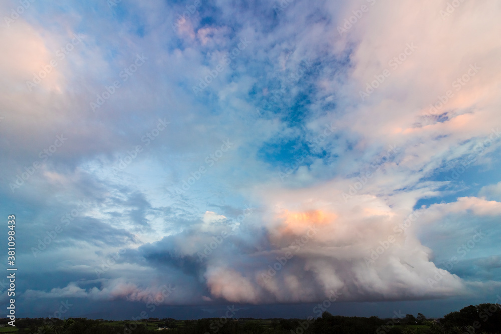 Dramatic cloudscape & mountainscape from Anglesey of storm clouds above the Snowdonia Mountain Range, North Wales 