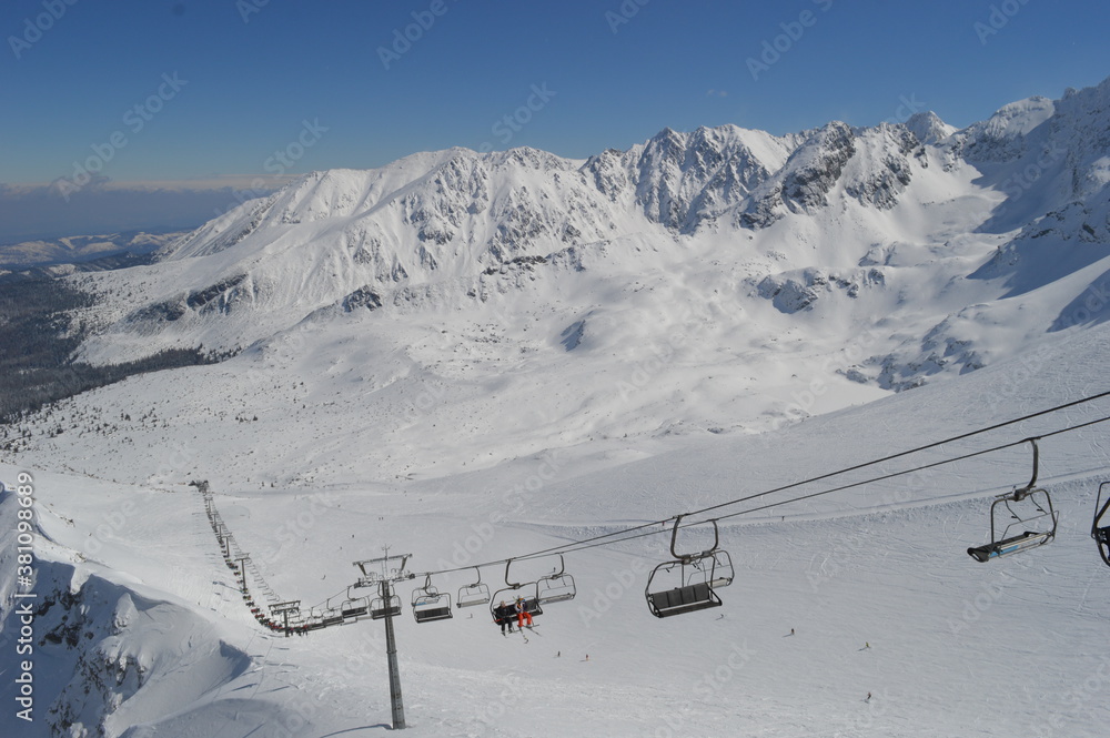 Fototapeta premium Skiing and snowboarding in the Jasna and Zakopane ski resorts between Poland and Slovakia in the Tatra Mountains