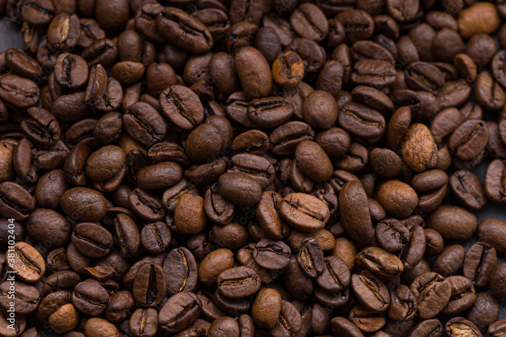 roasted aromatic coffee beans closeup sprinkled on a table roasted aromatic coffee beans closeup sprinkled on a table