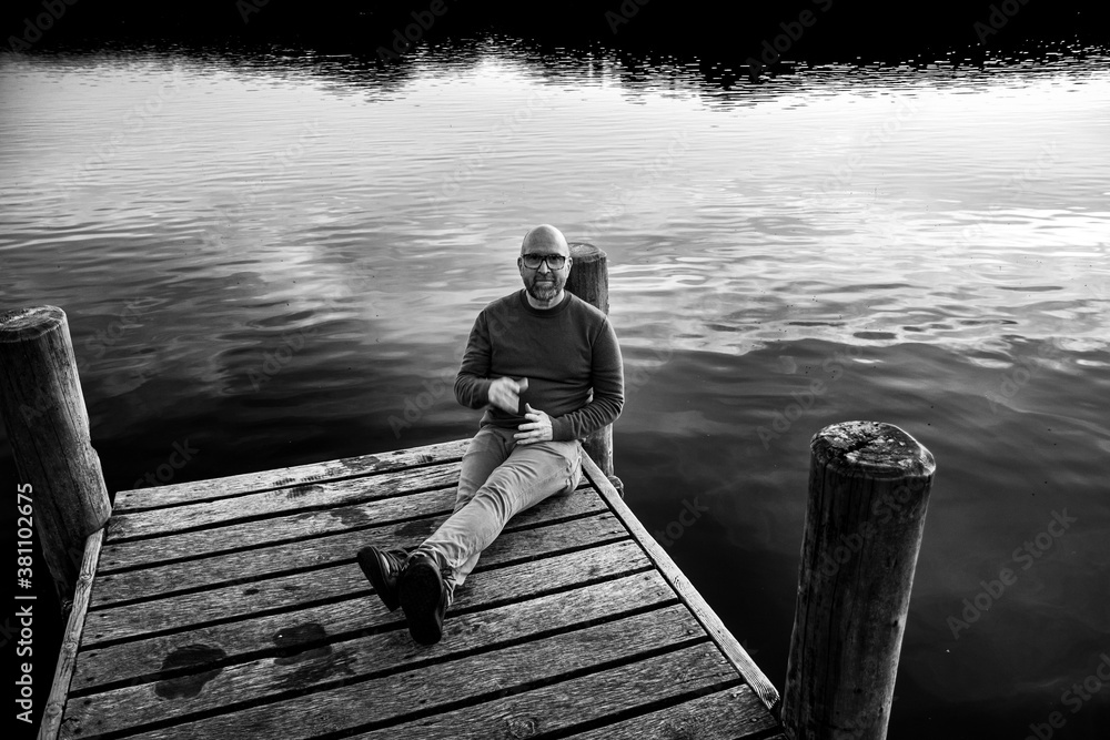 person sitting on a pier