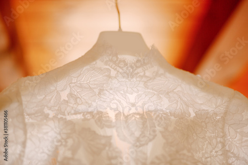 Close-up of the collar of a white dress for a wedding ceremony.