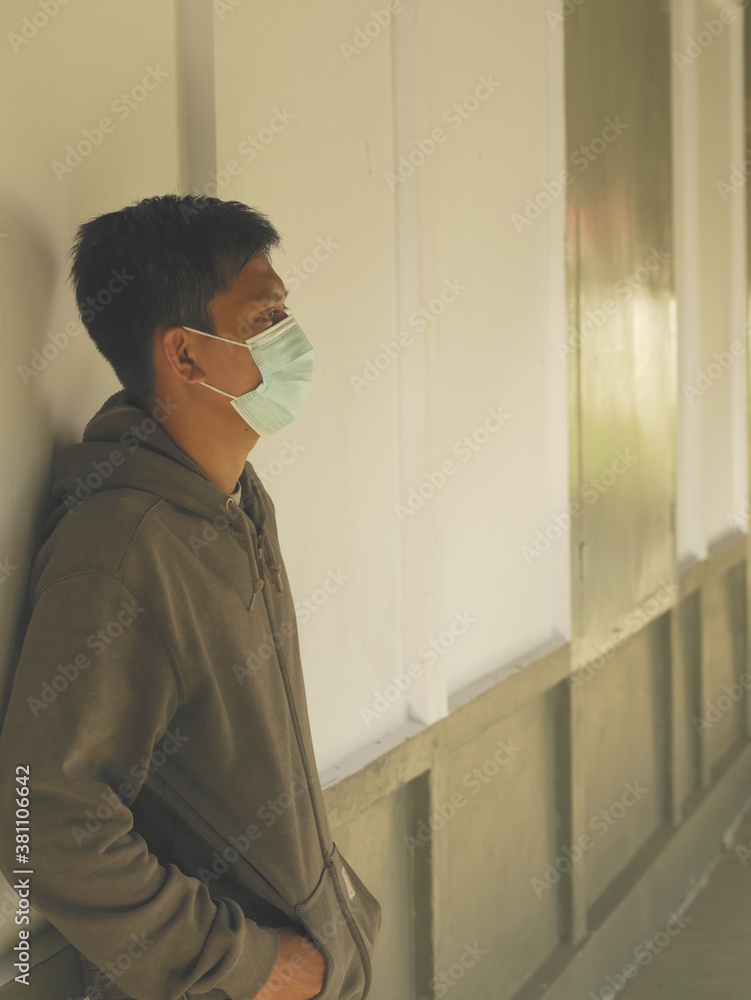 Protrait of an Indonesian young man using a medical mask during the Covid-19 pandemic. Handsome Indonesian guy wears a surgical mask to protect himself from coronavirus Protrait of an Indonesian young man using a medical mask during the Covid-19 pandemic. Handsome Indonesian guy wears a surgical mask to protect himself from coronavirus