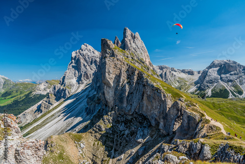 Seceda peak with a paraglider, Santa Cristina Val Gardena, Dolomites, South Tyrol, Italy