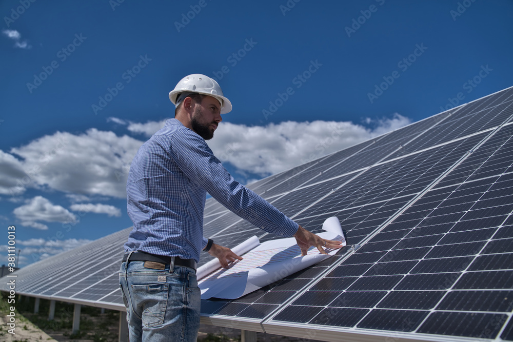 The engineer is checking the project of the solar station. The engineer is checking the project of the solar station.