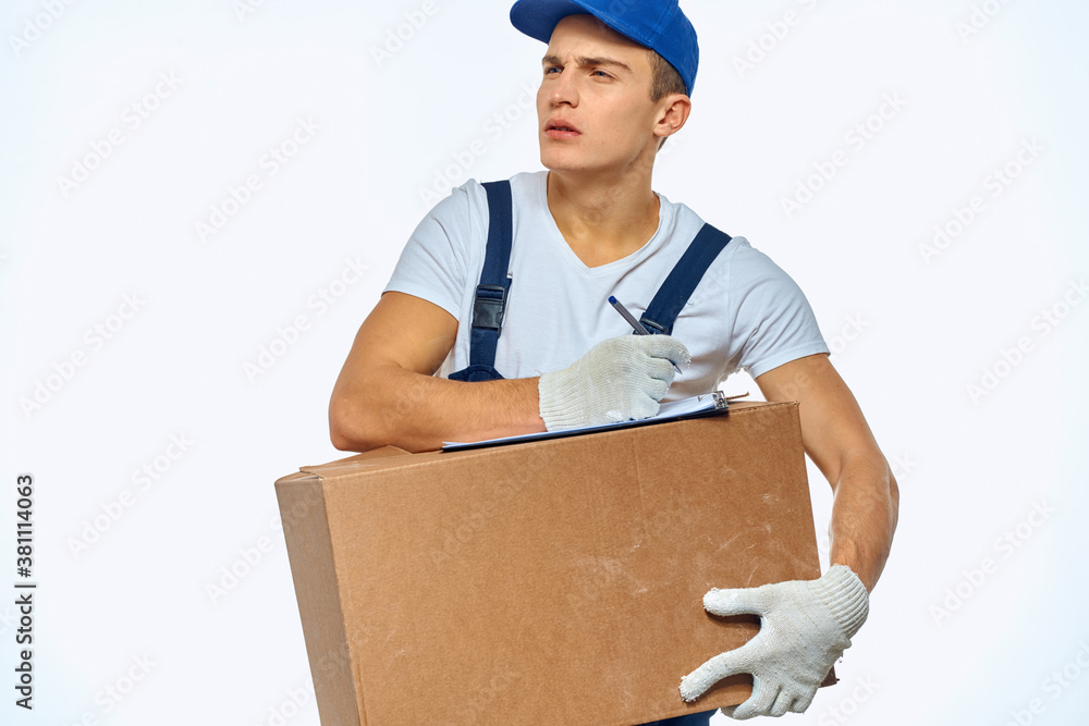 Man worker with box in hands delivery loading service work light background Man worker with box in hands delivery loading service work light background