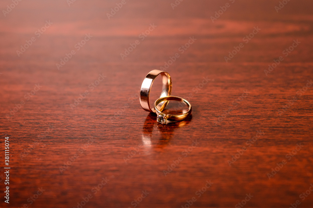 Gold wedding rings on a wooden background.Wedding attributes. Wedding ceremony