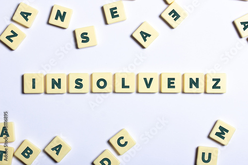 Das Wort Insolvenz mit Buchstaben aussenliegend auf weißem Hintergrund photo