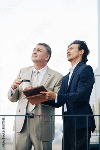 Construction company manager having meeting with investor and showing him new district