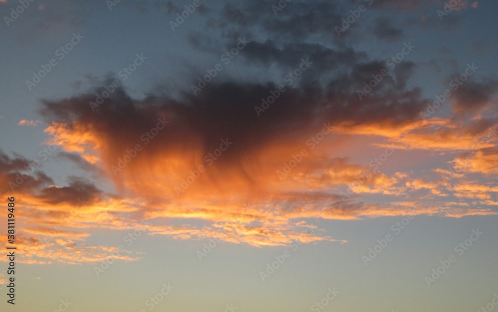 Beautiful orange clouds like flames in the sky at sunset, natural background