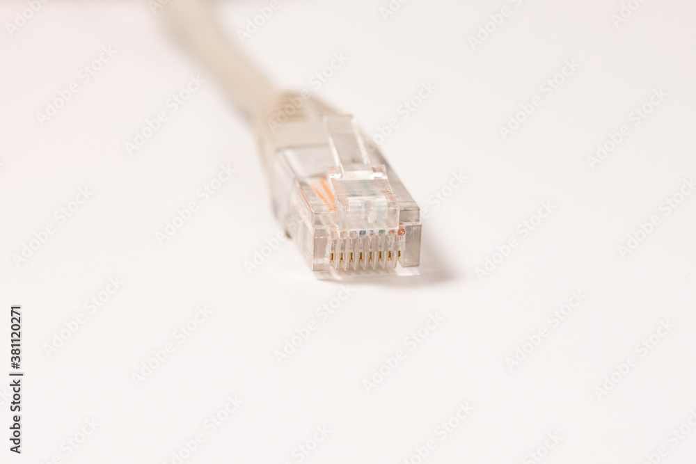 Gray Network Cable with molded RJ45 plug isolated against white background. Gray Network Cable with molded RJ45 plug isolated against white background.