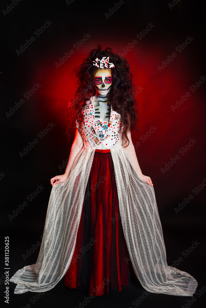 Girl dressed as a witch on Halloween ta dark red background