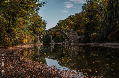Fototapeta Naklejka Na Ścianę i Meble -  Ancient stone bridge in water reflection