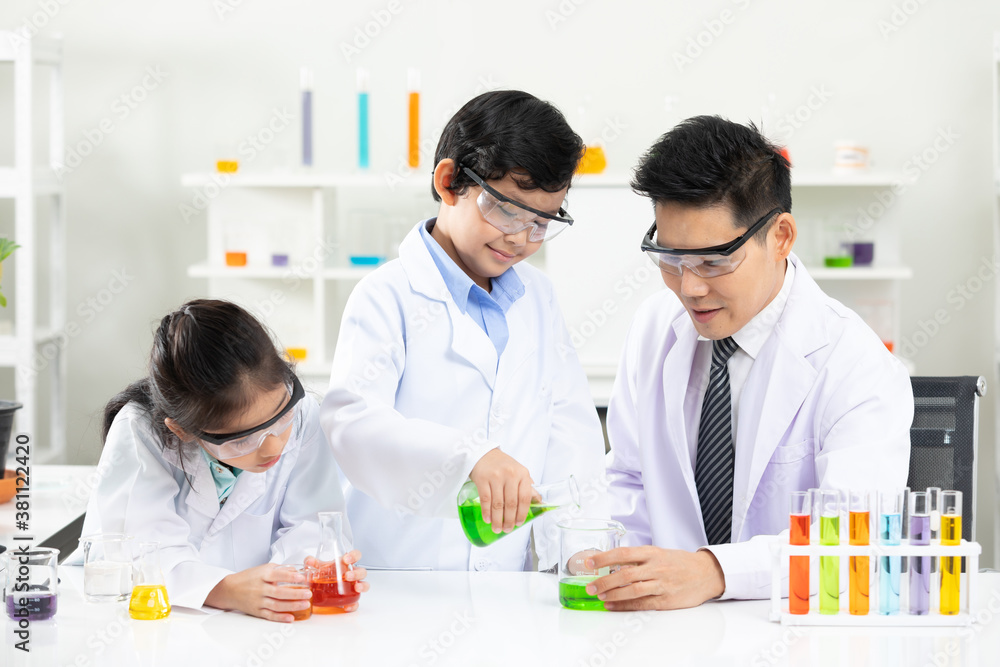science teacher doing or testing a chemical experiment with child students in laboratory classroom science teacher doing or testing a chemical experiment with child students in laboratory classroom