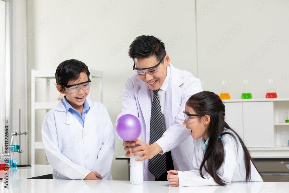 Fototapeta premium science teacher doing or testing balloon blow up experiment from bottle with child students