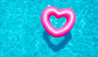 Inflatable rose heart buoy swim in the swimming pool view from above