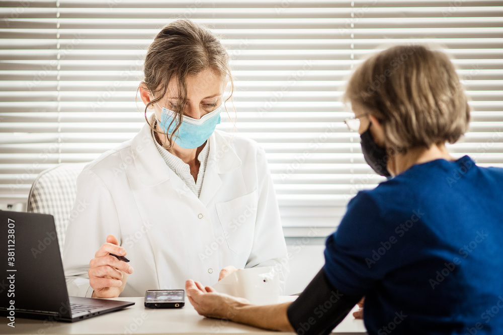 female doctor consulting a patient wearing medical mask female doctor consulting a patient wearing medical mask
