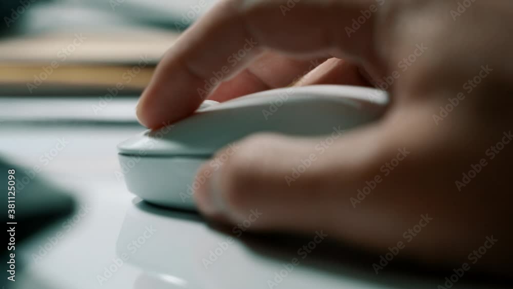 White computer mouse on a work desk. Working with a PC and click on the mouse. Footage of the workplace in 4K