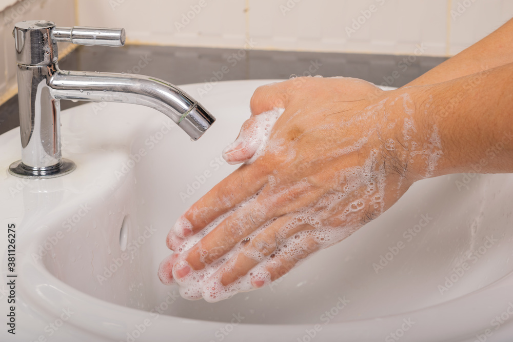 Man washes his hands with soap at home before and after do activity to prevent coronavirus (COVID-19).Hygiene concept. Man washes his hands with soap at home before and after do activity to prevent coronavirus (COVID-19).Hygiene concept.