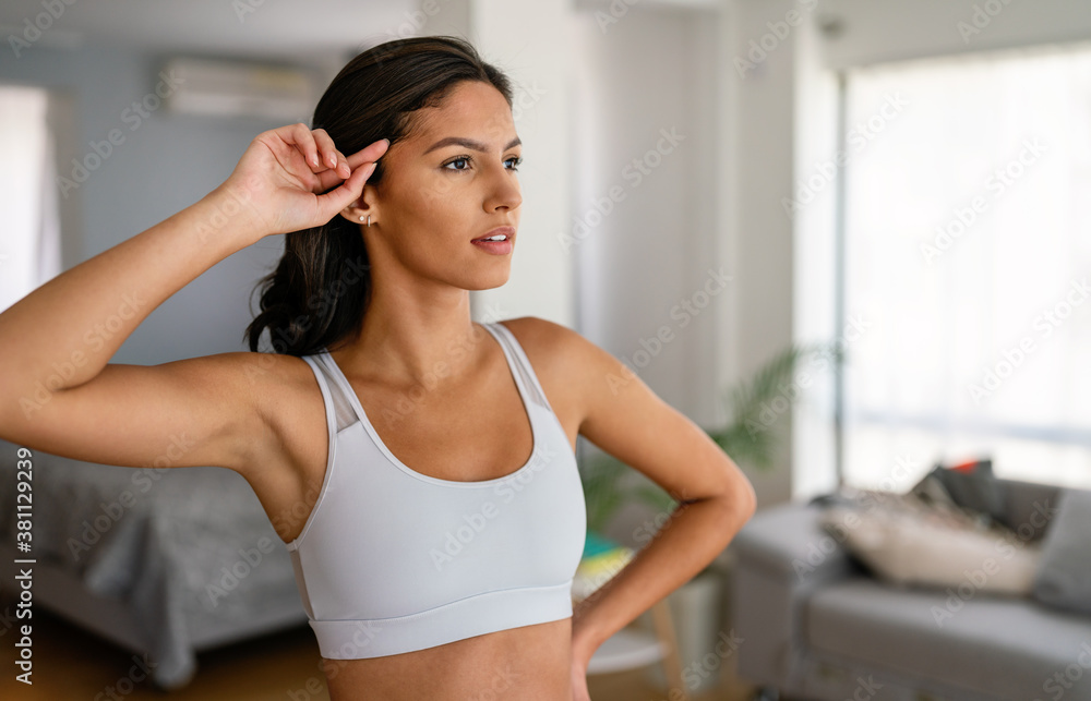 Sporty beautiful woman exercising at home to stay fit Sporty beautiful woman exercising at home to stay fit