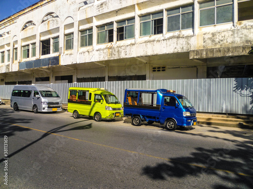 Colorful minibuses await tourists for city tours in Phuket.