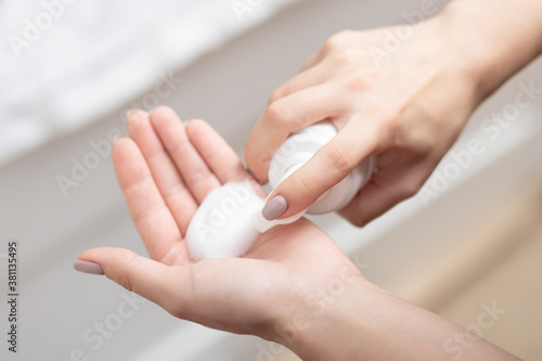 Beauty and face care, women's hands with foam for washing photo