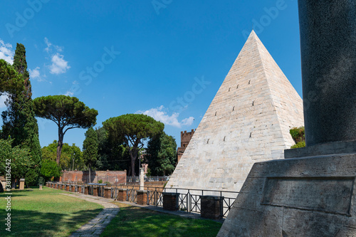 The Piramide Cestia or Pyramid of Cestius seen from the park of the non-Catholic cemetery is the only Egyptian-style pyramid in Rome. In the background the Aurelian walls at Porta San Paolo. Italy.