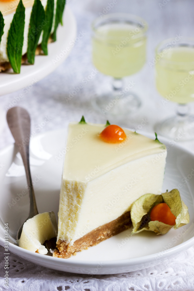 Mousse cake with cream, condensed milk and lime juice, garnished with jelly and physalis, served with limoncello.