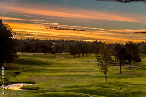 Colorful sunrise at a golf course.