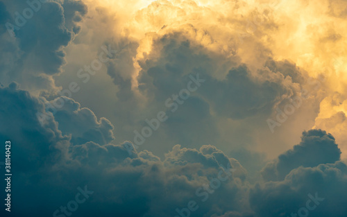 Obraz na plátně A close up of some clouds lit by golden light in amongst the storm