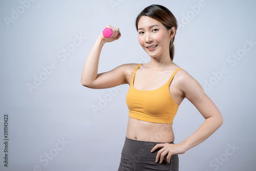 Beautiful fit Asian woman exercising with dumbbells, Isolated on white background.