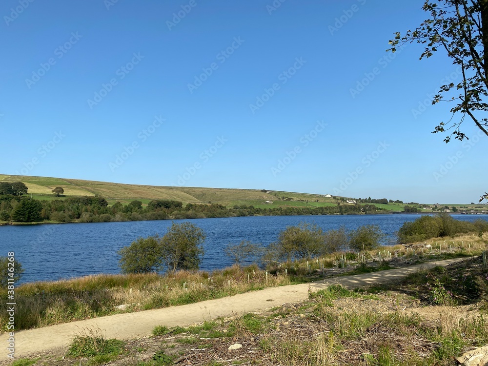 Looking along Baitings Reservoir, with trees, farmhouses, and dark blue water, on a summers day near, Ripponden, Halifax, UK Looking along Baitings Reservoir, with trees, farmhouses, and dark blue water, on a summers day near, Ripponden, Halifax, UK