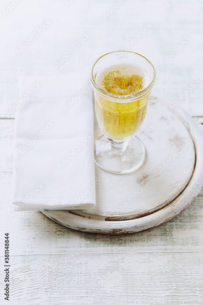 Glass of beer on bright wooden background.	