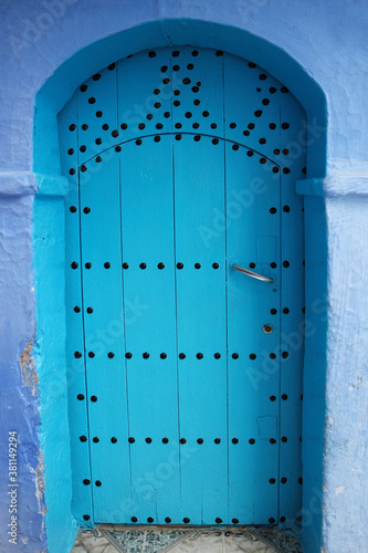 Traditional beautiful door in blue city of Chefchaouen, Morocco. Typical moroccan architecture. © Serhii