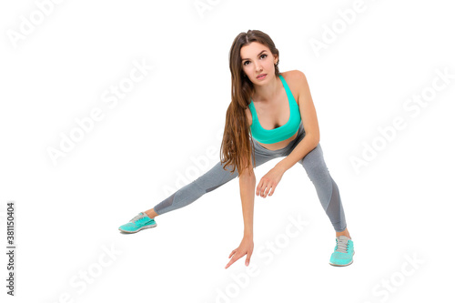 Woman in sportswear doing exercises on the body warm up jogging 