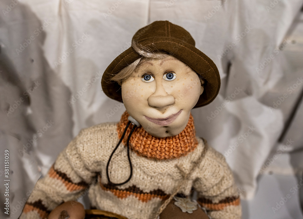 mockup of an old doll fairytale character cheerful tourist in a sweater and a hat