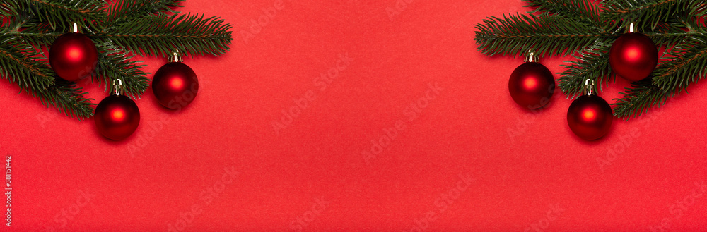 Obraz premium Red Christmas balls banner on red background, red baubles. New year concept.