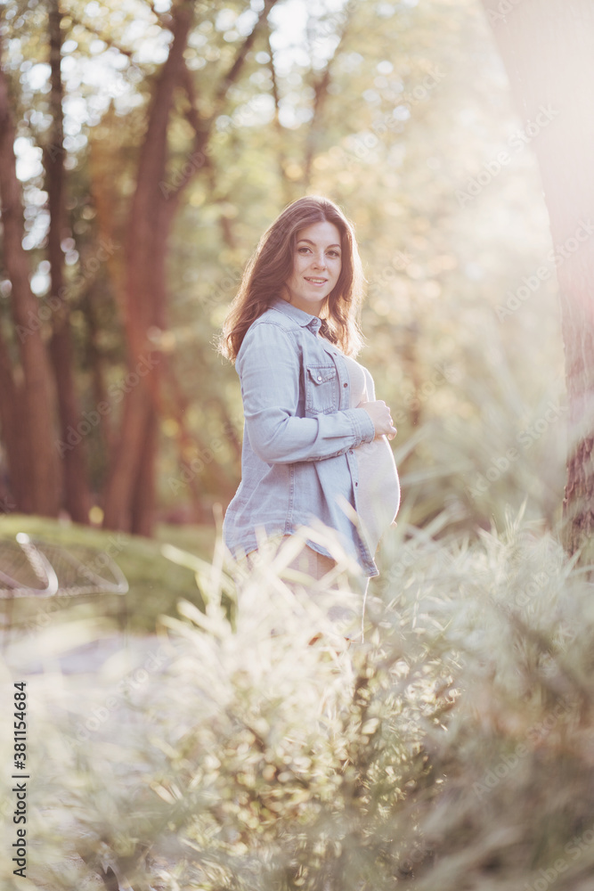 Pregnant woman walking in the park. Pregnancy Pregnant woman walking in the park. Pregnancy