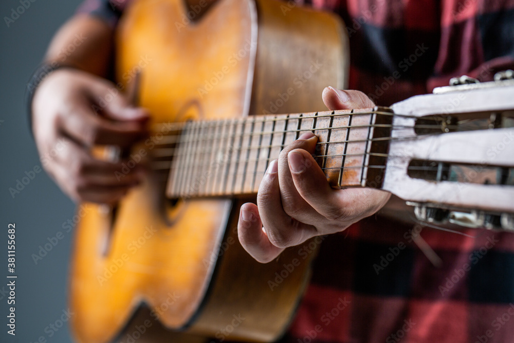 Man's hands playing acoustic guitar, close up. Acoustic guitars playing. Music concept. Guitars acoustic. Live music. Music festival. Male musician playing guitar, music instrument