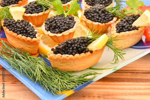 Tartlets with black caviar