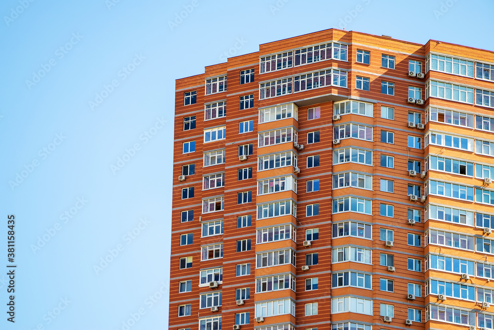 Fototapeta premium Brick building with windows on sky background