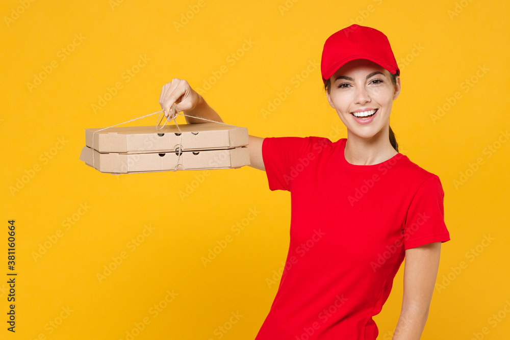Delivery employee woman in red cap blank t-shirt uniform work courier service during quarantine coronavirus covid-19 virus hold give food order pizza in cardboard flatbox isolated on yellow background Delivery employee woman in red cap blank t-shirt uniform work courier service during quarantine coronavirus covid-19 virus hold give food order pizza in cardboard flatbox isolated on yellow background