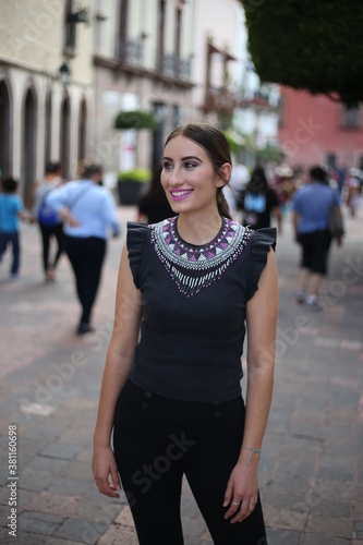 Portraits of a charming red-haired girl with a cute face. Girl posing for the camera in the city center. She has a wonderful mood and a lovely smile, mexican lifestyle, mexican concept queretaro © Mylifeontopdm